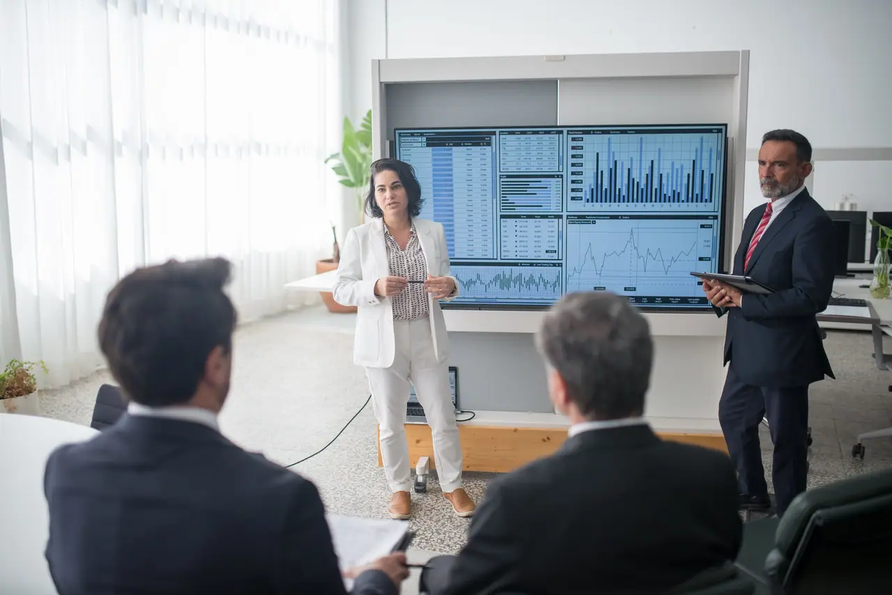 A presenter walking leaders through outcome dashboards